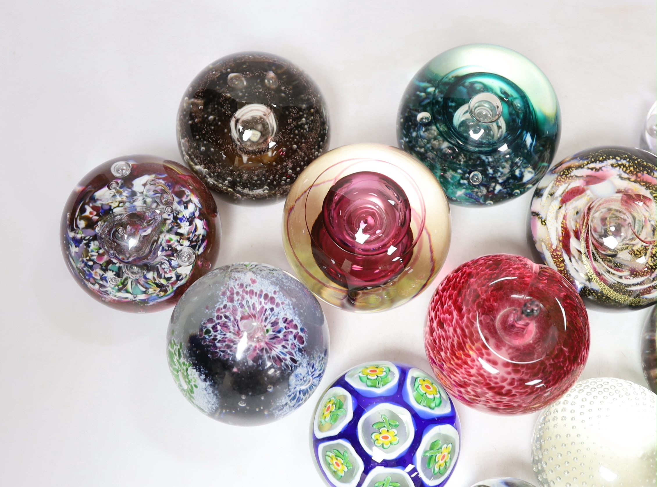 Thirteen glass paperweights including Caithness and Murano, largest 9cm in diameter